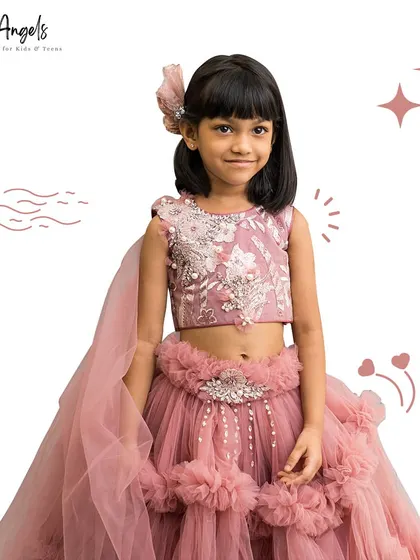 This dusty rose lehenga is all about texture, with a frilled skirt, an embroidered top, and a flowing dupatta.