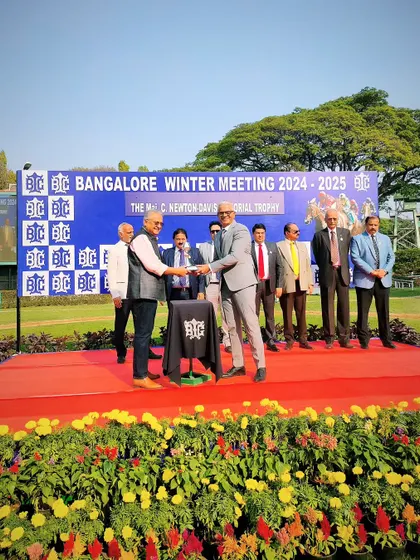 Mr. Dayanand R. Mandre presents The Maj. C. Newton-Davis Memorial Trophy to the owners of Sicyon.