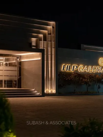 A closer perspective of the HLP Galleria facade at night. The illuminated brand signage and layered architectural elements work together to establish a strong, sophisticated presence.