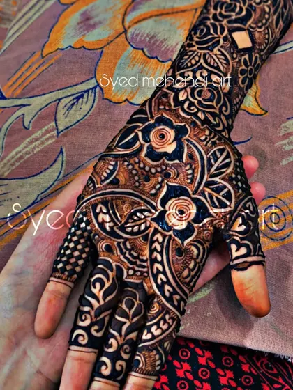 A close-up of a single hand from a bridal set, held by another person to showcase the design.