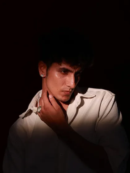 Another angle from the same moody series, this time with the model's hand to his neck. This pose adds a touch of vulnerability to the otherwise intense portrait.
