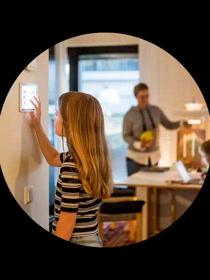 A family interacts with a wired smart home system, showcasing its seamless integration into daily life for users of all ages.