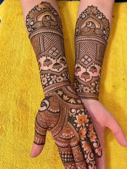 This design is rich with auspicious symbols like the Swastika and jhumkas, combined with peacock motifs and intricate jaal patterns. A perfect choice for weddings and festivals.