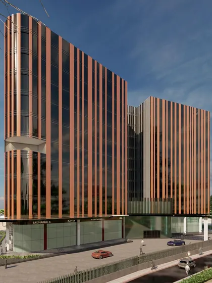 This rendering showcases the entrance and ground floor of the solar passive building. The upper floors' protective fins contrast with an open and transparent ground level, designed to engage with the surrounding public space.