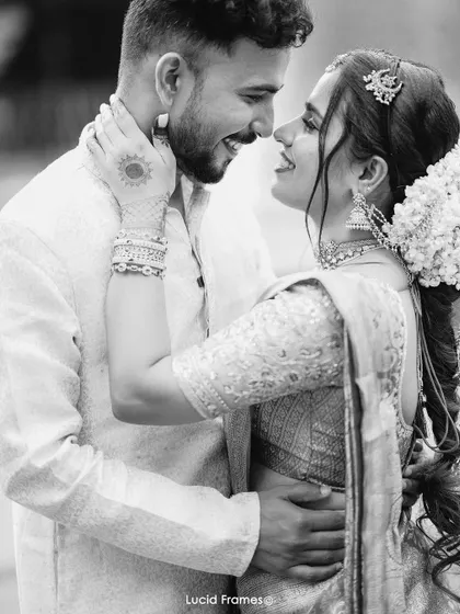 A joyful black and white portrait of a couple, their happiness evident in their smiles and embrace.