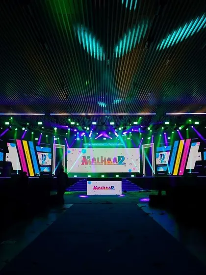The vibrant, custom-branded stage for the 'Malhaar' corporate event. My VJ setup integrates seamlessly with the event's theme and branding for a cohesive look.