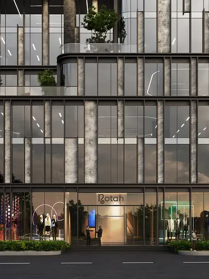The ground level of the Bandra commercial tower, showcasing its sleek, streamlined sensibility. Expansive glass walls dissolve the boundary between exterior and interior, creating a transparent and inviting entrance.