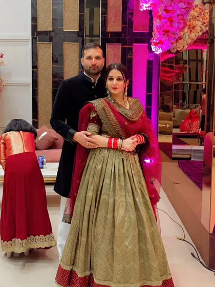 A beautiful portrait of the new bride in her custom lehenga. The combination of olive green and red is both traditional and unique.