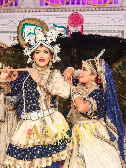 I specialize in bringing cultural stories to life. This Raasleela performance, set against a backdrop of peacock feathers, features dancers in detailed Radha and Krishna costumes, creating a divine and visually stunning experience for everyone.