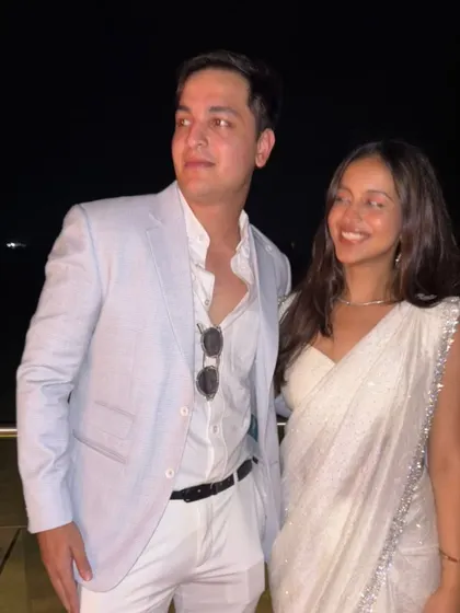 A candid moment showcasing the effortless style of the Arctic Blue linen jacket. It's the perfect piece for creating memories, whether at your best friend's landmark birthday or a destination shaadi.