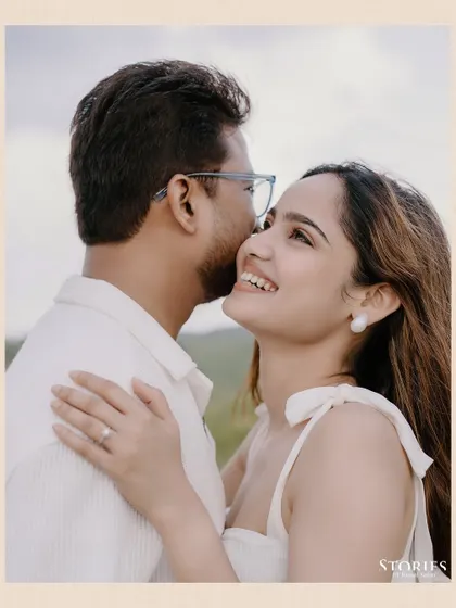 A tender close-up portrait from the Udaipur shoot, capturing a sweet kiss on the cheek and a genuine smile.