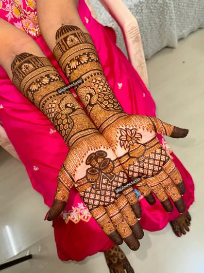 A beautiful bridal design featuring peacocks on the arms and traditional wedding pots (kalash) on the palms.