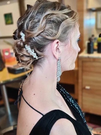 A textured, wavy updo for a glamorous evening event. I used pearl accessories to add a touch of elegance and tie in with her jewelry.
