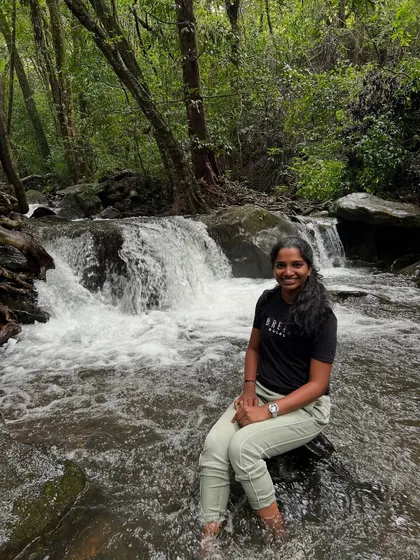 A trekker enjoying the cool, clear water of a stream on the way to Netravathi Peak.