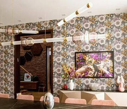 An angled view of the Luna Kaleido installation, showing how its intersecting forms create a dynamic, multi-layered composition. The fixture interacts beautifully with the art and patterns in the room.