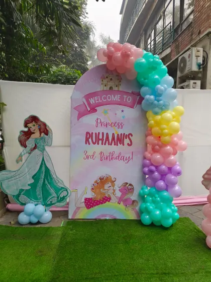 A welcome sign for Princess Ruhaani's 3rd birthday, featuring an Ariel cutout and a pastel balloon arch.