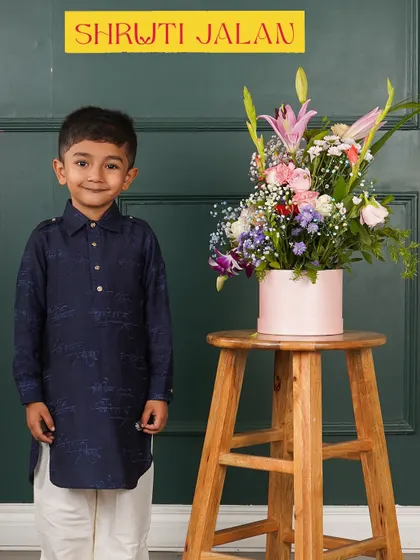 For a modern and minimal look, I designed this navy blue pathani-style kurta. It's a chic and comfortable option for any stylish little gentleman.