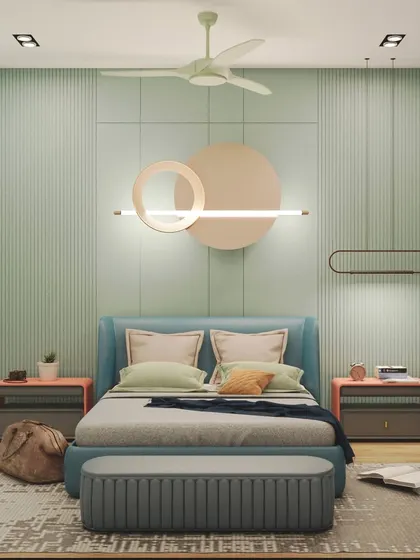 A serene and playful bedroom design featuring a calming mint green paneled wall and pops of peach. The unique circular light fixture acts as a piece of art, adding personality to the space.