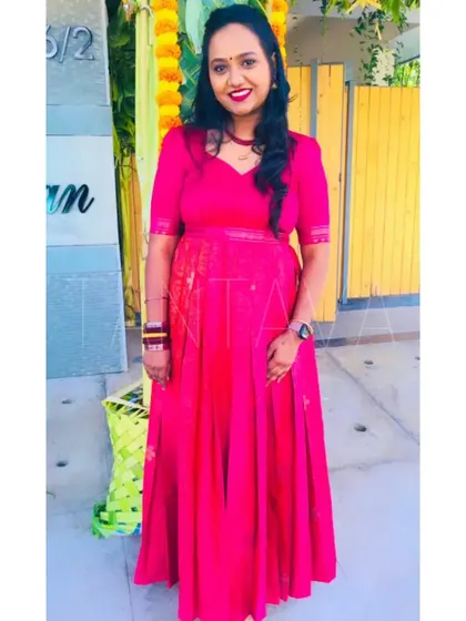 Here is the front view of the bright pink upcycled gown. It's a classic silhouette that lets the beautiful color and fabric of the original saree shine.