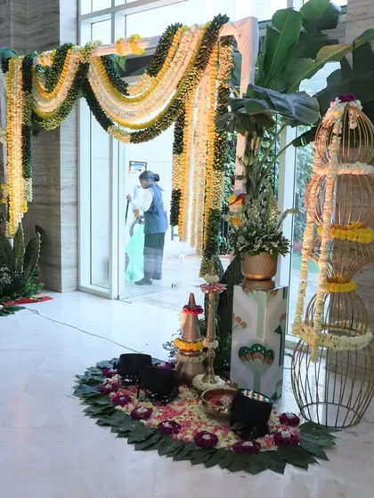This entrance for a traditional ceremony uses garlands of marigolds and banana leaves. The decor is simple yet significant, creating an auspicious and culturally rich welcome for all the guests.