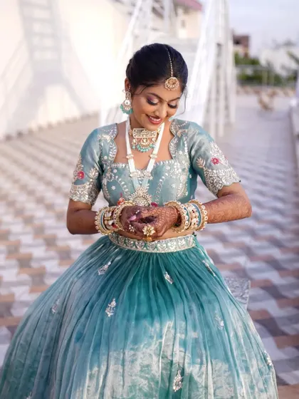 Admiring the details. The soft glam makeup allows her natural beauty and the intricate jewelry to shine.