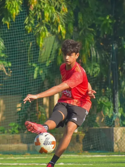 A player striking the ball, captured at the moment of impact. We focus on proper shooting technique.