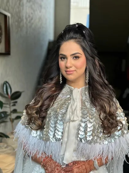 A carnival-ready look with a high half-ponytail and soft waves.