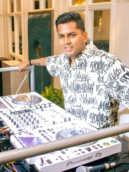 Posing with my all-white Pioneer DJ setup at Grey Cravings in Mumbai. The right equipment is essential for a professional performance.