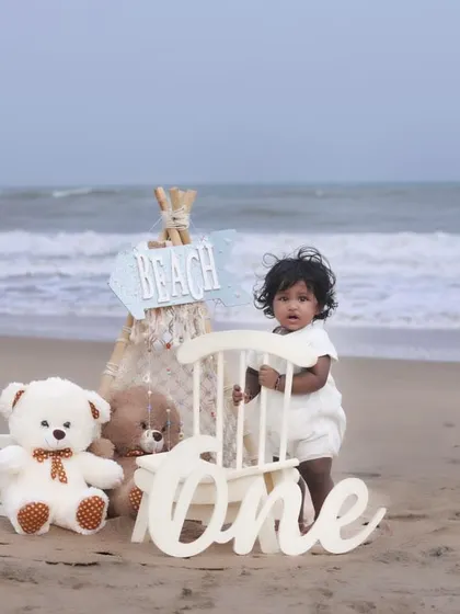 Let's take the celebration outdoors! This first birthday beach photoshoot combines a beautiful natural setting with our curated props for a unique and memorable milestone session. We handle the setup so you can enjoy the moment.