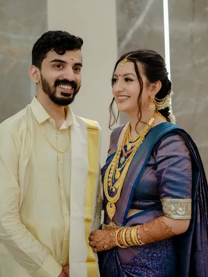 A happy couple shot. Aparna's makeup enhances her joyful expression, and she looks absolutely radiant next to her husband.