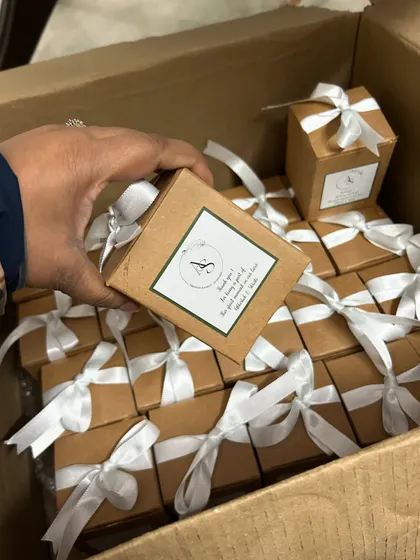 The final presentation for a wedding return gift order. Each candle is individually boxed and tied with a satin ribbon, making them feel like a special present for every guest.