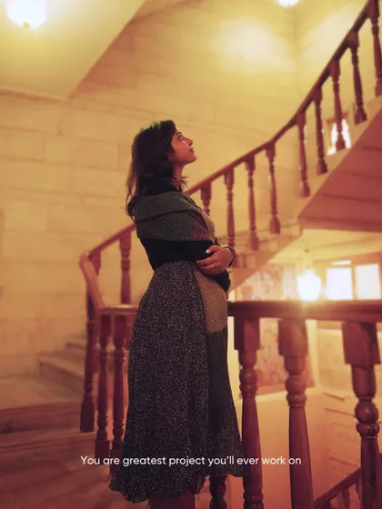 A portrait on the stairs inside a haveli in Jaisalmer. The warm, ambient light and traditional architecture create a very moody and atmospheric setting.