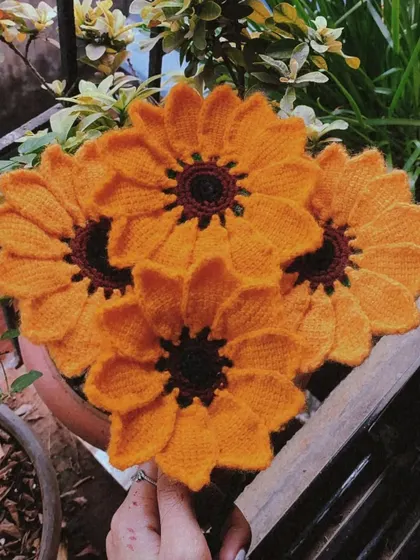 A beautiful bouquet of handmade crochet sunflowers. Their bright, cheerful faces are guaranteed to make anyone smile.