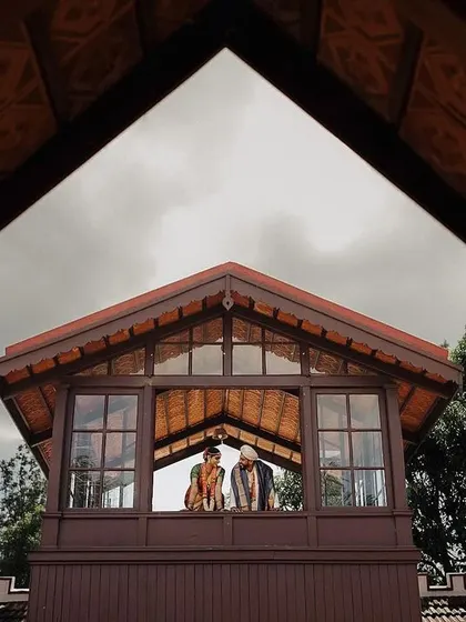 A unique, architecturally framed portrait of the couple. Looking out from a balcony, this shot uses strong lines and perspective to create a powerful and artistic image.