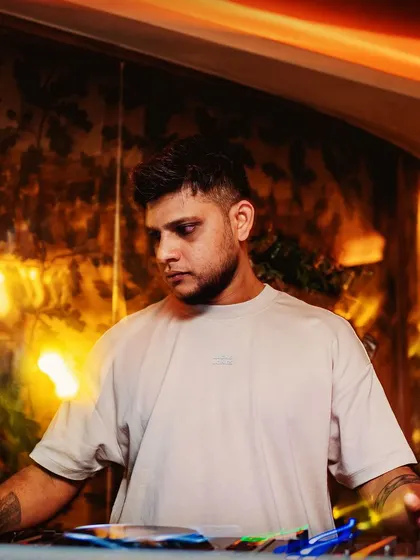 A clean, professional shot of me at the decks. This is the look of focus before a big set.