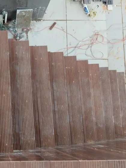Ribbed wooden planks being installed for a staircase, showcasing another application of our outdoor wood solutions.