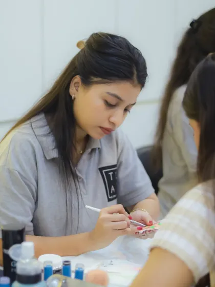 A trainer demonstrating a technique to a student. We emphasize a hands-on, practical approach to learning in all our courses.