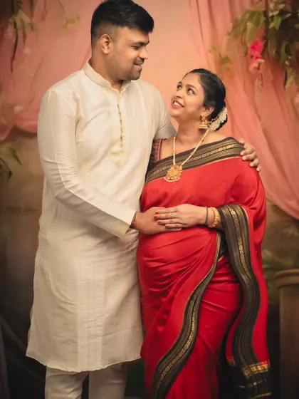 An intimate couple's portrait, capturing the loving gaze between partners dressed in beautiful traditional outfits.