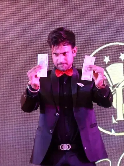 Performing a money multiplication trick on stage. Illusions involving money always capture the audience's imagination.