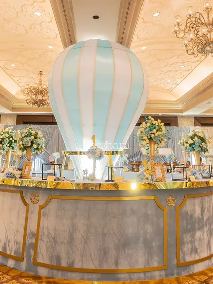 A custom circular bar was created for the event, topped with a large hot-air balloon prop. This continued the whimsical fairground theme and served as a functional and stylish beverage station.