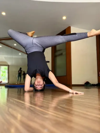 A full split in a headstand is an advanced skill that showcases both elite flexibility and core strength.