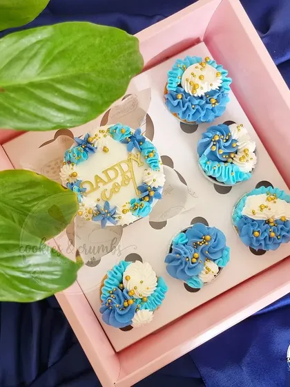 A box of "Daddy Cool" themed cupcakes in blue and white. These were part of my Father's Day collection and feature detailed piping and gold accents.