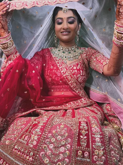 A playful moment with the veil. The makeup is set to be flawless, even during the most candid and fun moments of the wedding.