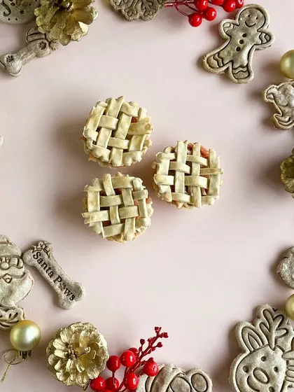 Look at these adorable mini lattice pies I bake for Christmas. They are filled with pet-safe ingredients and are the perfect bite-sized holiday treat for your dog.