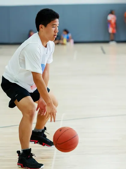 A young player focused on his dribbling during a training session.