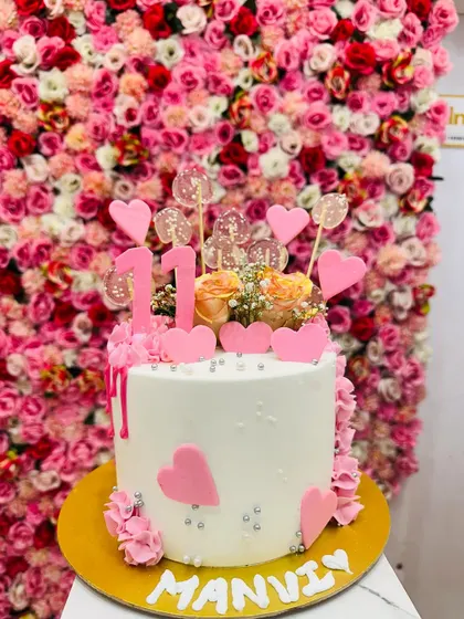A beautiful cake for a 13th birthday, marking the official start of the teenage years. The pink hearts and lollipops make it fun and celebratory.