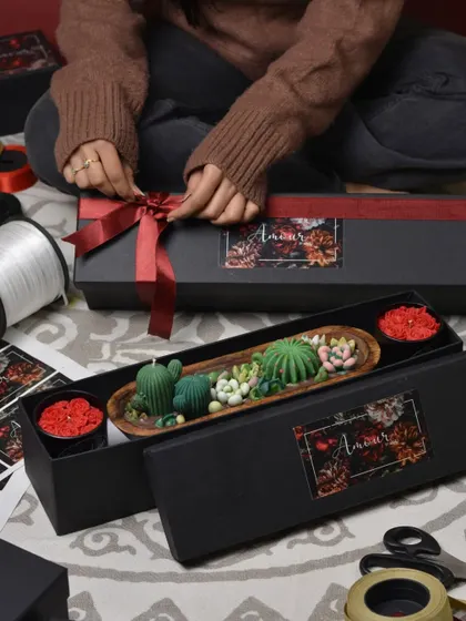 My 'Phool aur Kante' (Flowers and Thorns) Gift Box is a unique and thoughtful gift. It combines the beauty of two rose candles with the rustic charm of a cactus and succulent wooden bowl candle.