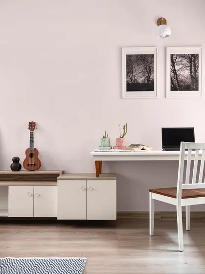 A minimalist room with a floating work desk and a low-profile media console, creating a functional and clutter-free space.