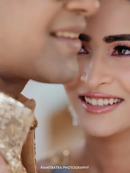 A beautiful close-up of the bride, her sparkling eye makeup and radiant smile capturing the joy of the moment.