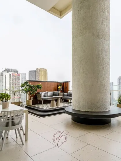 This shot showcases the thoughtful layout of the terrace, with a large structural pillar cleverly integrated into the design with a circular bench.